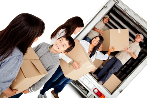 Removal van and packed household boxes for a house move in Marks Gate