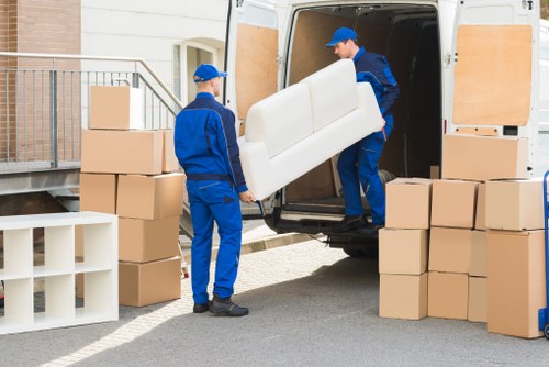 Removal van and moving boxes in a residential Marks Gate street