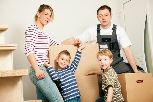 Local moving team arranging items inside a removals van