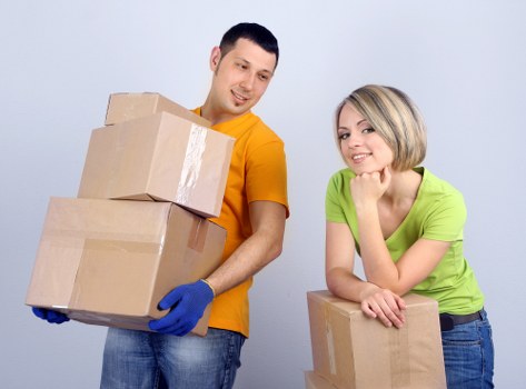 Professional movers carrying furniture during a home move in Marks Gate