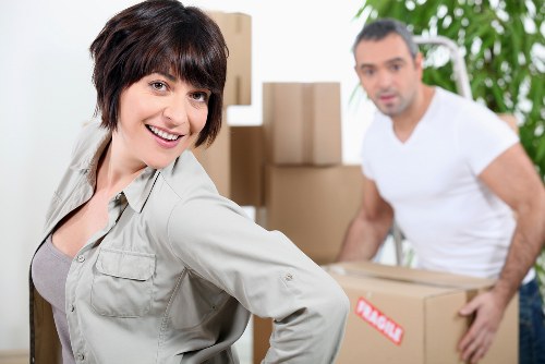 Professional movers transporting office items through a local commercial property