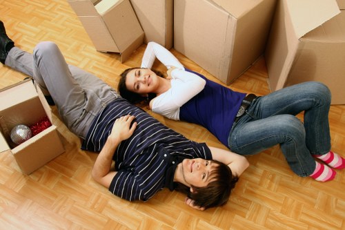 Team handling furniture during a house removal in Marks Gate